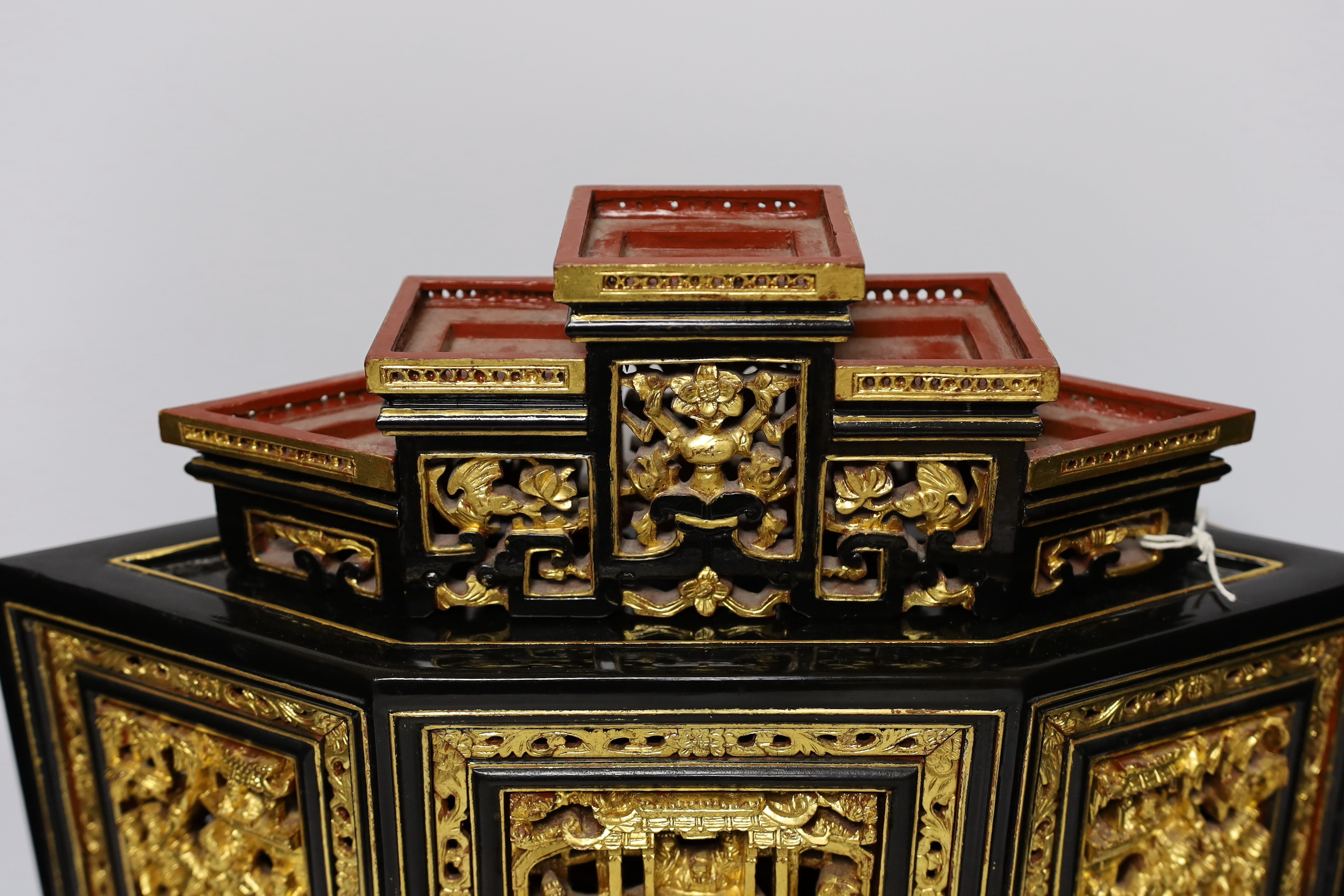 A 20th century Chinese carved lacquered wood altar stand, 49cm wide